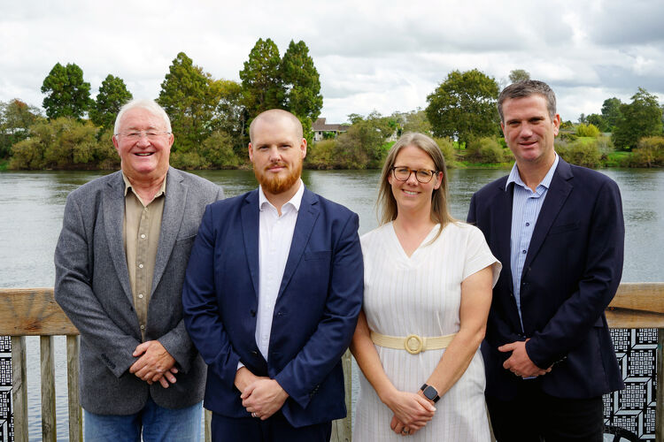 The North Waikato Law team standing together in front of the Waikato River